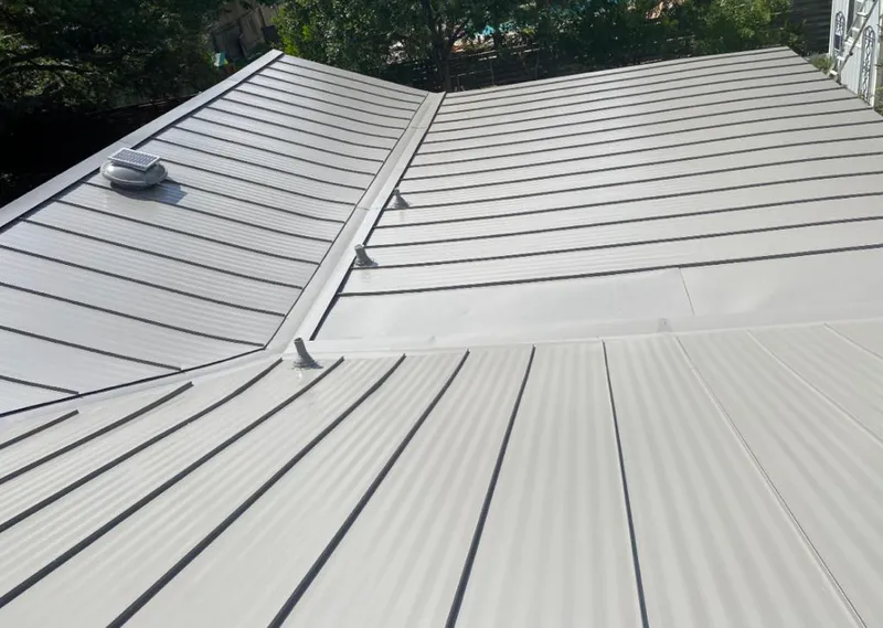 Solar attic fan installed on a metal roof for Roof Ventilation in Charles City